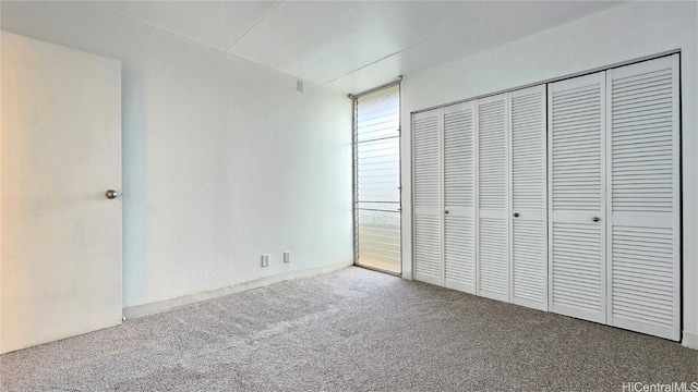 unfurnished bedroom with carpet floors and a closet