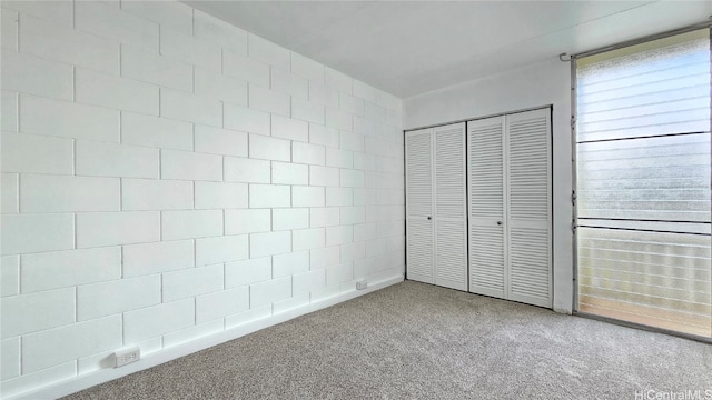 unfurnished bedroom with carpet flooring and a closet