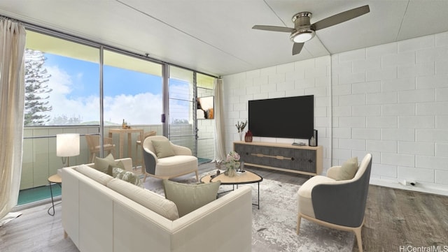 living room with a wall of windows, wood finished floors, and a ceiling fan