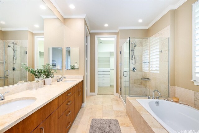 bathroom with vanity, crown molding, and shower with separate bathtub