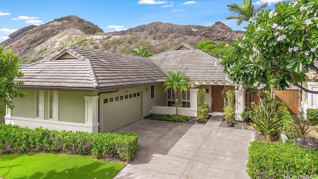 view of front facade featuring a garage and a mountain view