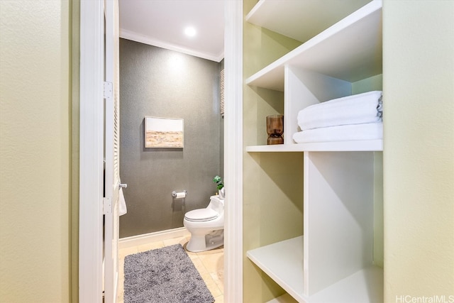 bathroom featuring toilet, ornamental molding, and tile patterned flooring