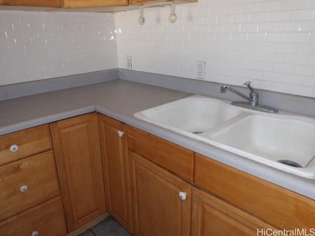 85-175 Farrington Hwy Unit C315, Waianae, HI 96792 - kitchen with a sink, tasteful backsplash, brown cabinetry, and light countertops