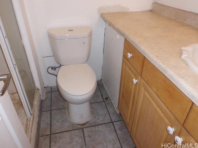 bathroom featuring toilet, vanity, and tile patterned floors