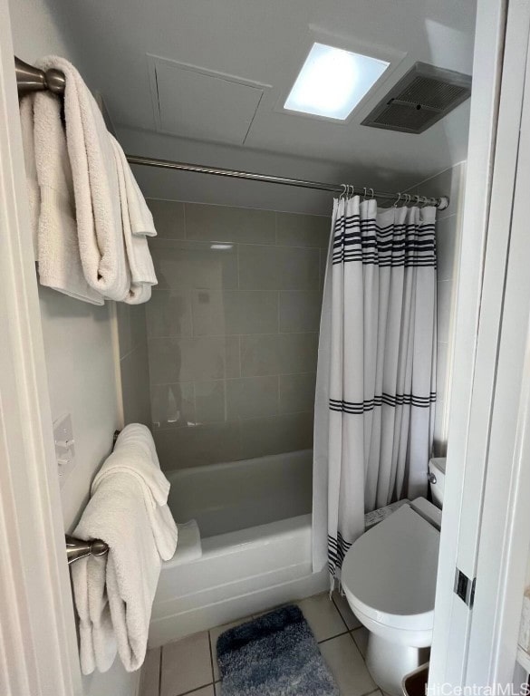 bathroom featuring toilet, shower / tub combo, and tile patterned flooring