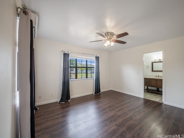 unfurnished bedroom with dark hardwood / wood-style flooring, ensuite bath, and ceiling fan