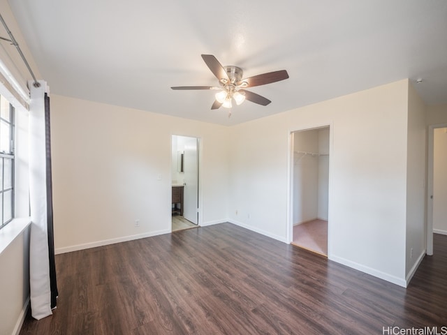 empty room with ceiling fan and dark hardwood / wood-style flooring