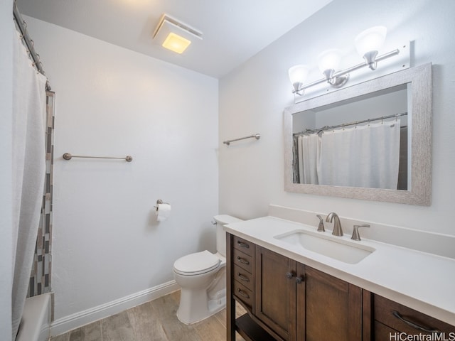 full bathroom featuring vanity, hardwood / wood-style flooring, toilet, and shower / bathtub combination with curtain