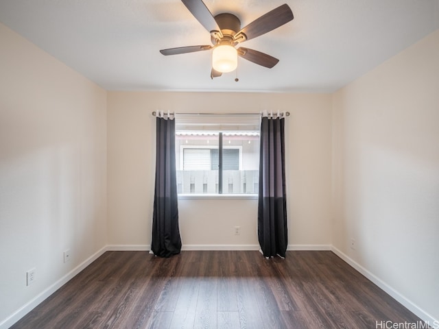 empty room featuring dark wood-type flooring and ceiling fan