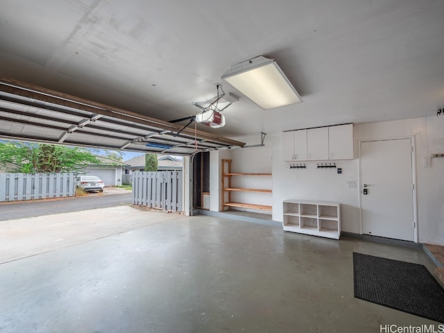 garage featuring a garage door opener and a carport