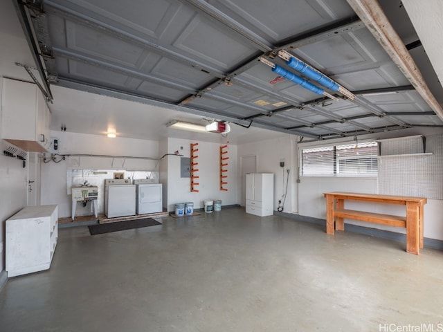 garage featuring a garage door opener and separate washer and dryer