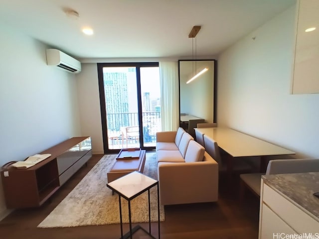 living area featuring dark wood-style floors, an AC wall unit, and floor to ceiling windows