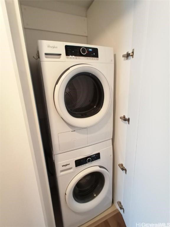 washroom featuring stacked washing maching and dryer