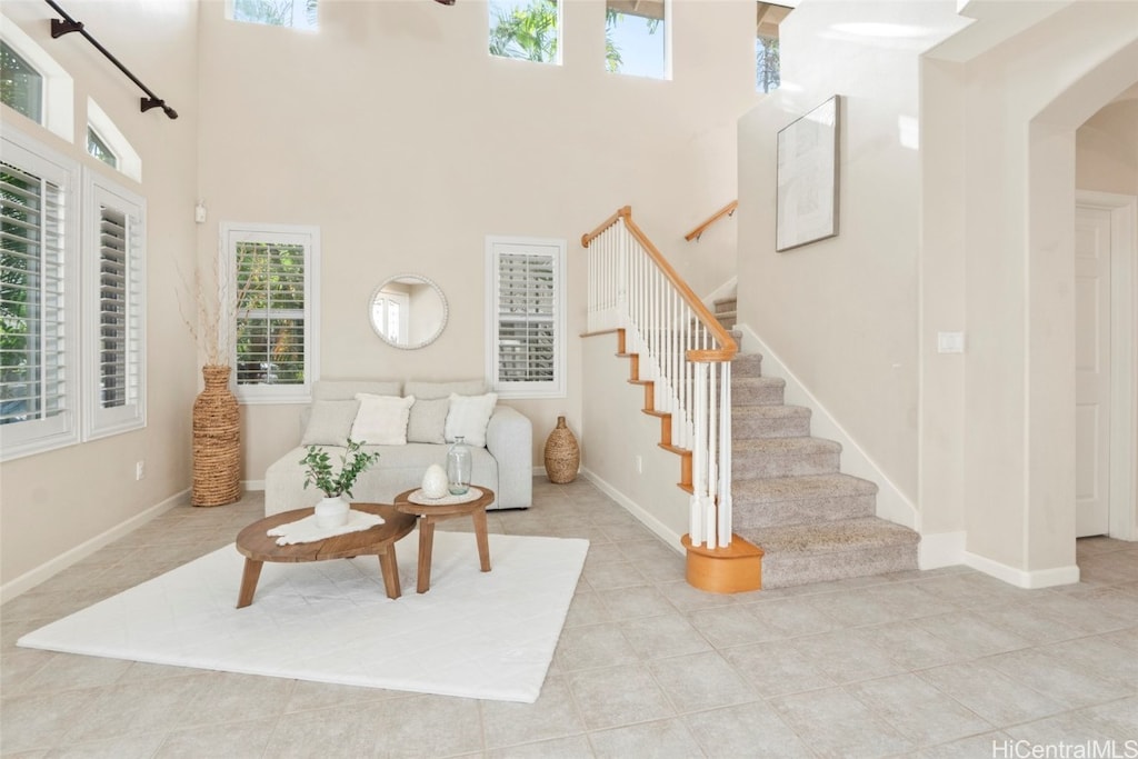 tiled living room with a high ceiling