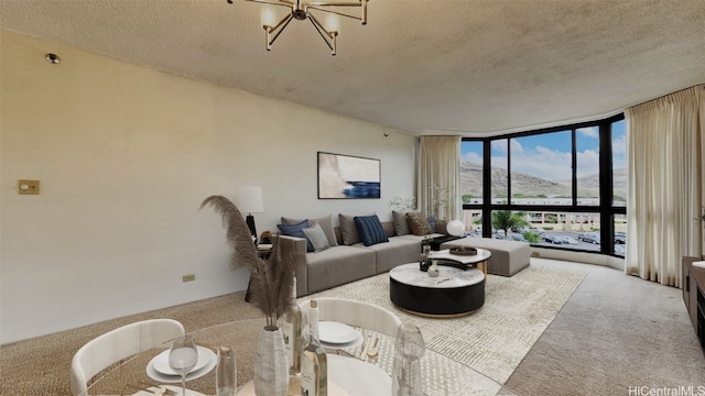 living room featuring a mountain view, expansive windows, a textured ceiling, and light colored carpet