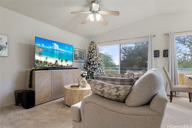 carpeted living room with ceiling fan, a healthy amount of sunlight, a textured ceiling, and lofted ceiling