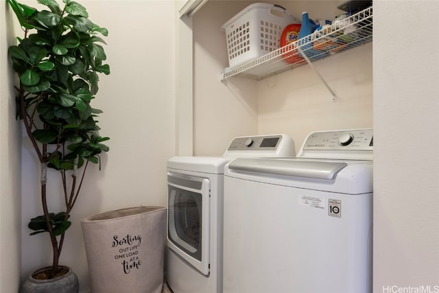 clothes washing area featuring independent washer and dryer