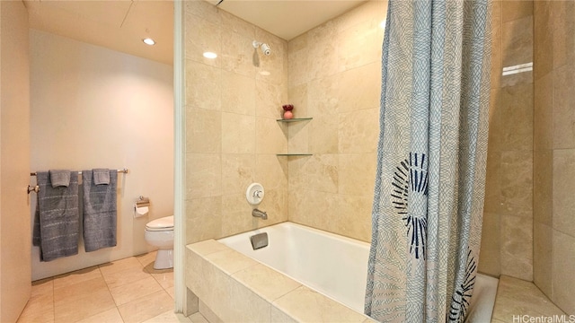 bathroom with tile patterned floors, shower / tub combo with curtain, and toilet