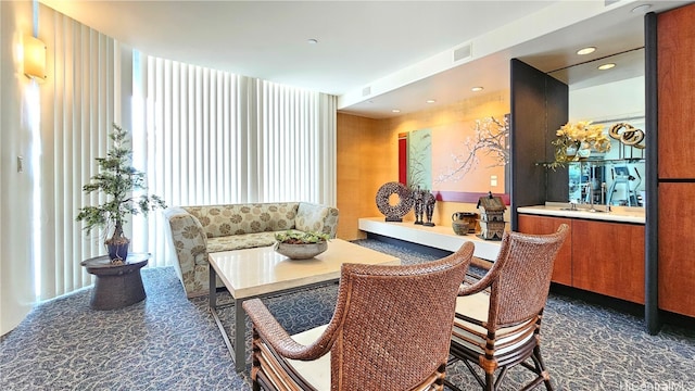 carpeted dining space with sink