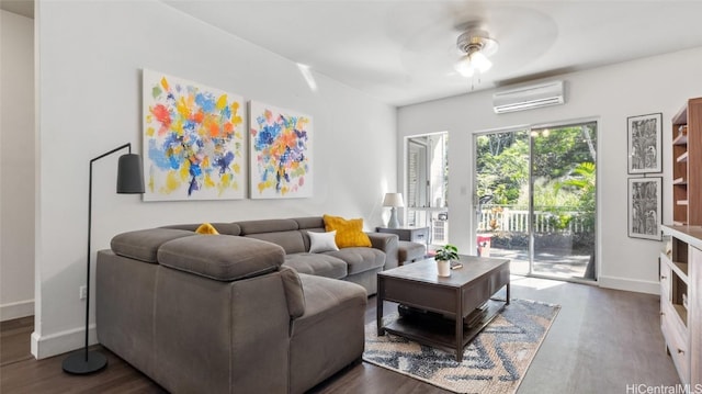 living room featuring a wall mounted air conditioner, ceiling fan, and dark wood-type flooring