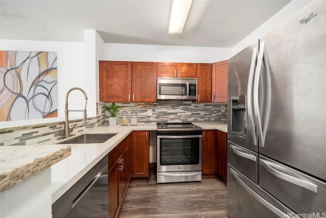 kitchen with sink, backsplash, appliances with stainless steel finishes, and dark hardwood / wood-style floors