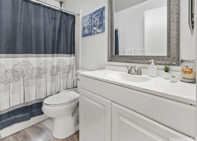 bathroom featuring vanity, toilet, hardwood / wood-style floors, and a shower with curtain