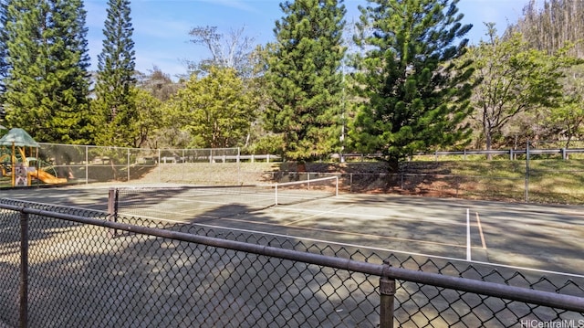 view of sport court featuring a playground