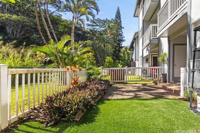 view of yard with a balcony