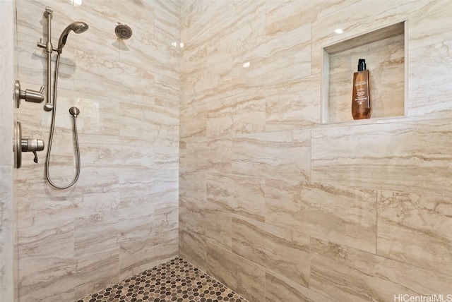 bathroom with tiled shower