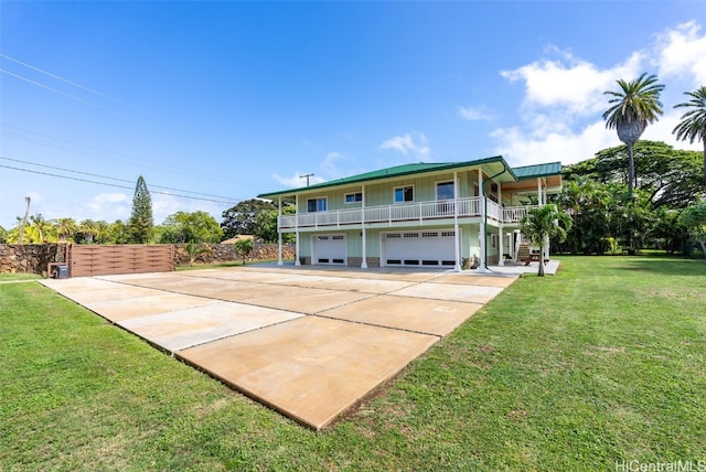 view of front of property with a garage, a balcony, and a front yard