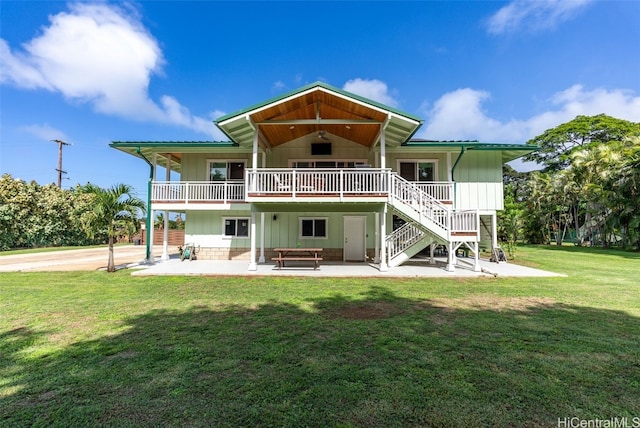 back of house with a yard and a patio