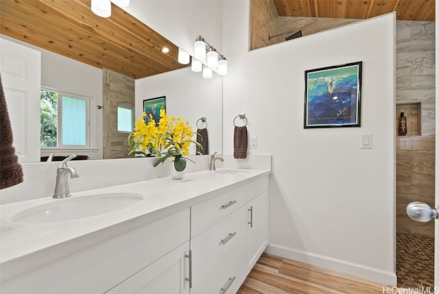 bathroom featuring vanity, hardwood / wood-style flooring, lofted ceiling, and wood ceiling