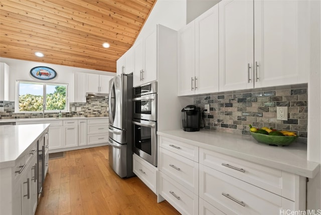 kitchen featuring wooden ceiling, light hardwood / wood-style floors, decorative backsplash, white cabinets, and appliances with stainless steel finishes