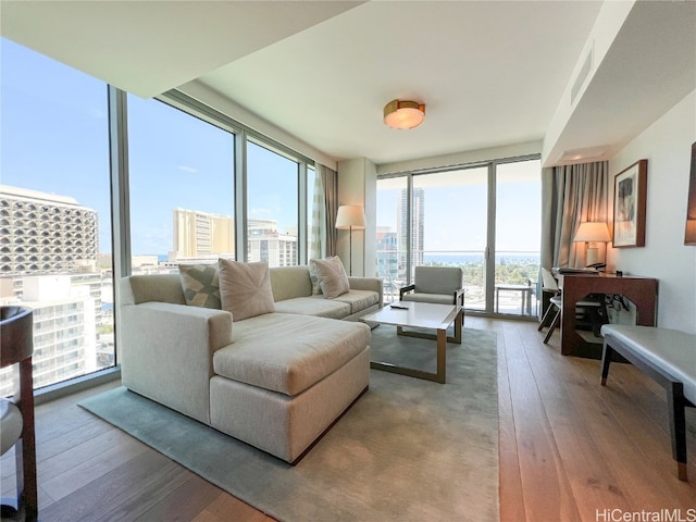 living room featuring wood-type flooring and floor to ceiling windows