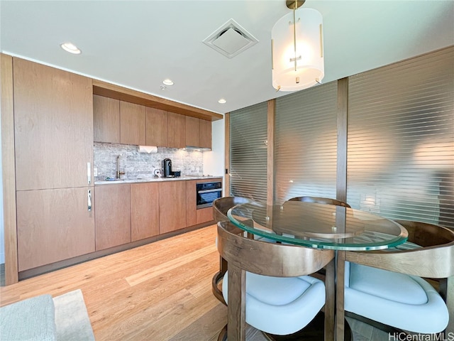 dining room featuring light hardwood / wood-style floors and sink