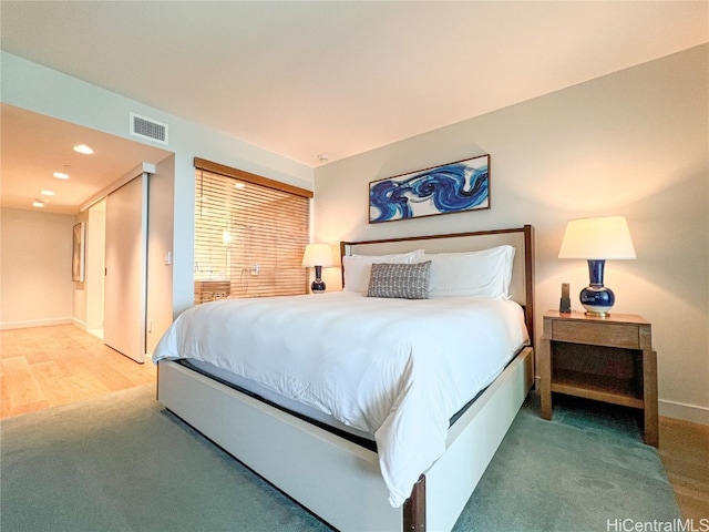 bedroom with hardwood / wood-style floors