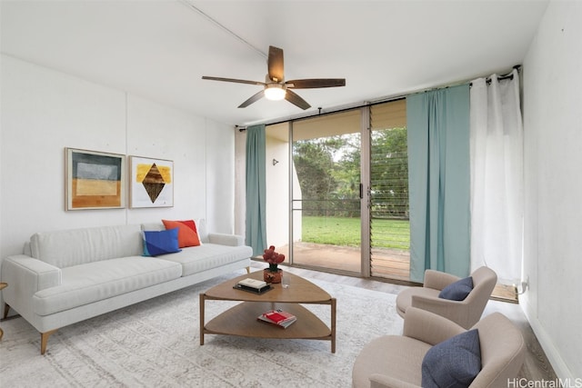 living room featuring ceiling fan and light hardwood / wood-style flooring