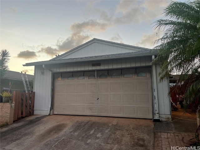 view of garage at dusk