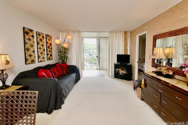 living room with brick wall and light carpet