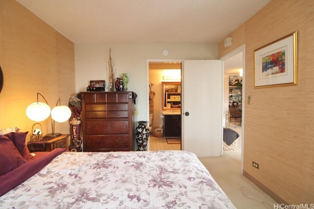 carpeted bedroom with ensuite bath