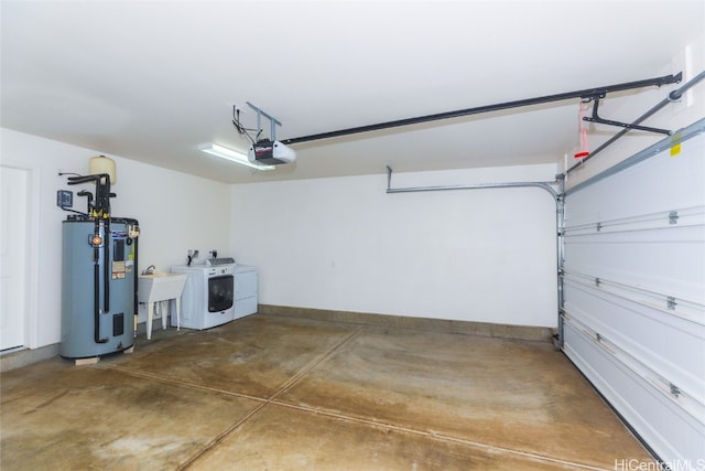 garage with independent washer and dryer, a garage door opener, sink, and water heater