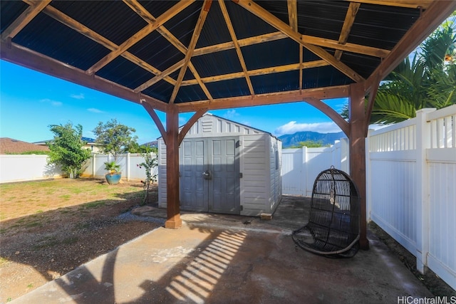 view of patio featuring a storage shed and a mountain view