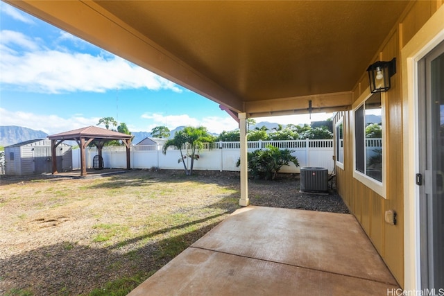 view of yard featuring a gazebo, cooling unit, a mountain view, and a patio