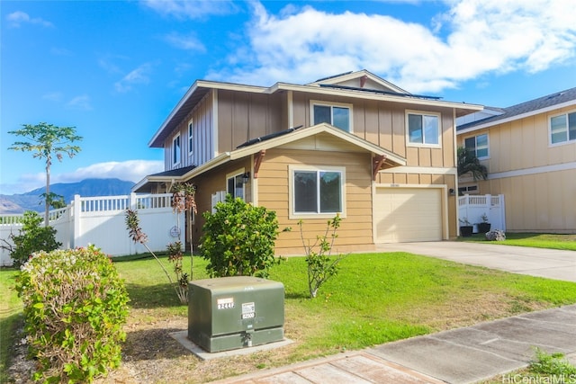 view of front of house featuring a mountain view, a front yard, and a garage