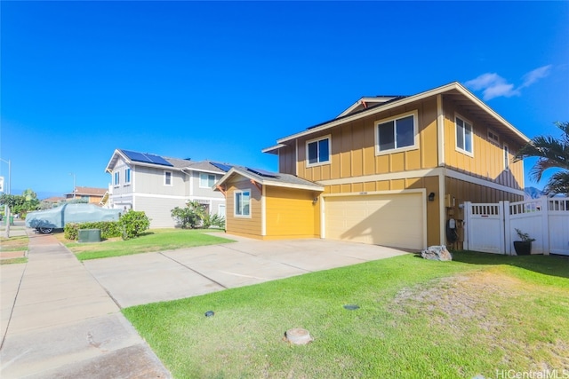 view of front of property with a front yard and a garage