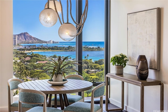 1100 Ala Moana Blvd Unit 1400/1402, Honolulu, HI 96814 - dining space with a water and mountain view, wood finished floors, and baseboards
