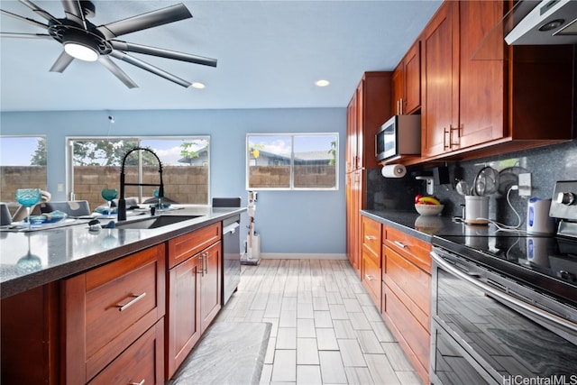 kitchen featuring stainless steel appliances, sink, tasteful backsplash, ceiling fan, and range hood