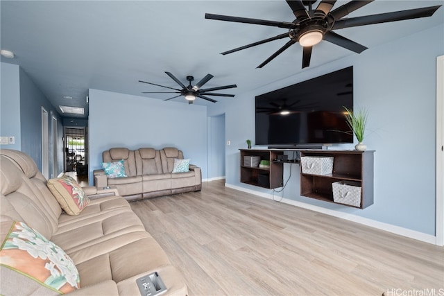 living room with light hardwood / wood-style flooring and ceiling fan