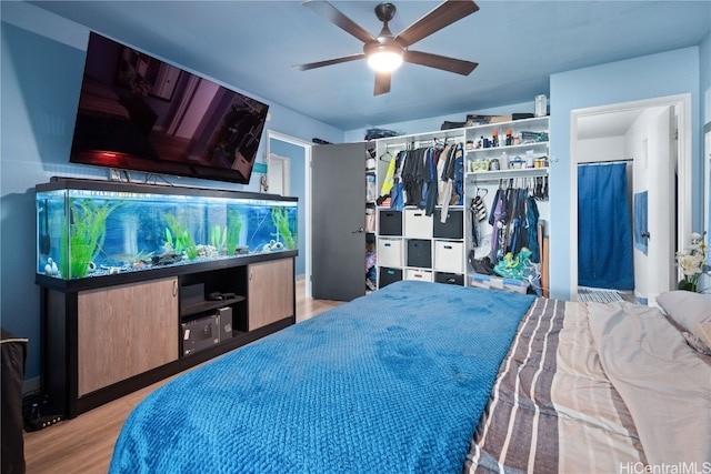 bedroom with a closet, ceiling fan, and light hardwood / wood-style floors