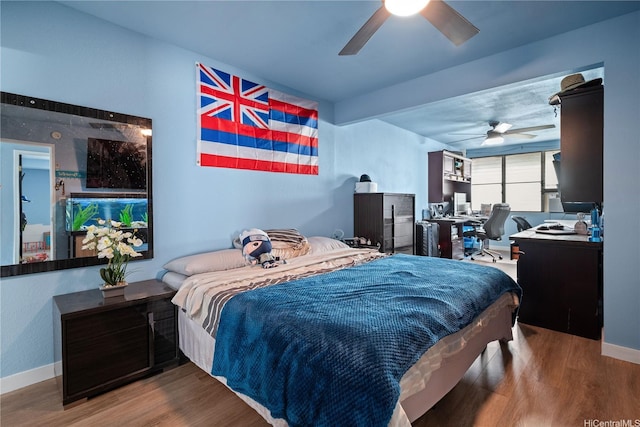 94-1420 Kahuli St, Waipahu, HI 96797 - bedroom with wood finished floors, a desk, and baseboards